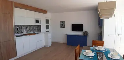 a kitchen with a table and a dining room at PRIMERA LINEA DE PLAYA EN VALDELAGRANA in El Puerto de Santa María
