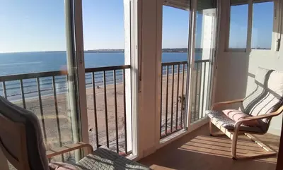 a room with a balcony with a view of the beach at PRIMERA LINEA DE PLAYA EN VALDELAGRANA in El Puerto de Santa María