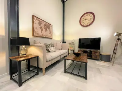 a living room with a couch and a tv at No 38 Cádiz in Cádiz