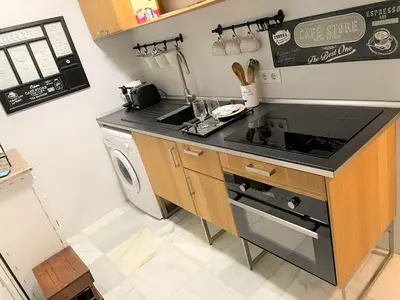 a kitchen with a stove top oven next to a dishwasher at No 38 Cádiz in Cádiz