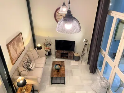 a living room with a couch and a tv at No 38 Cádiz in Cádiz