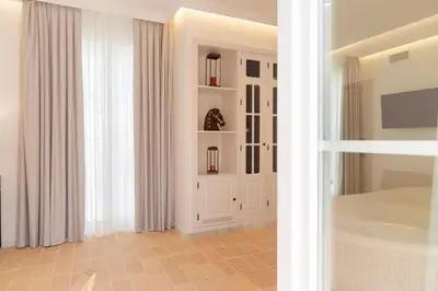 a bathroom with a white door and a window at Albariza Hotel Boutique in Sanlúcar de Barrameda