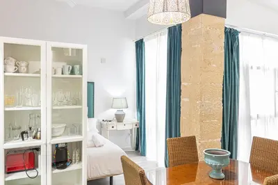 a living room with a table and a bedroom at Allo Apartments Amargura I Centro Loft in Jerez de la Frontera
