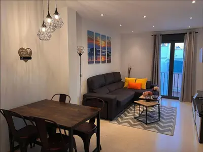 a living room with a couch and a table at La Gaviota & Parking privado Grupo AC Gestion in Cádiz