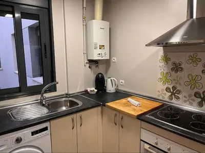 a small kitchen with a sink and a stove at La Gaviota & Parking privado Grupo AC Gestion in Cádiz