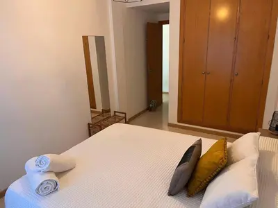 a bedroom with a bed with towels on it at La Gaviota & Parking privado Grupo AC Gestion in Cádiz