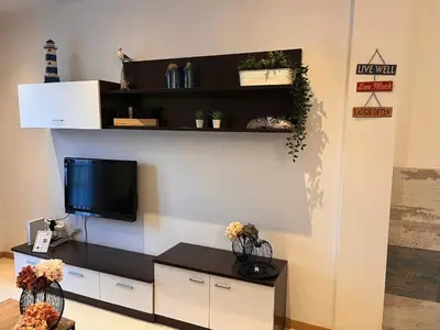 a living room with a tv on a wall at La Gaviota & Parking privado Grupo AC Gestion in Cádiz