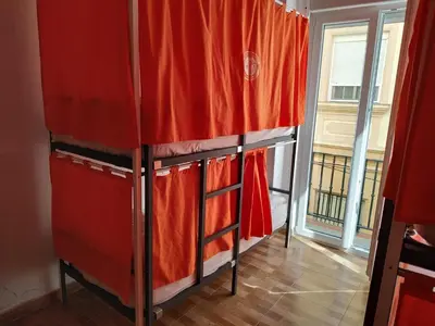 a group of bunk beds in a room with a window at Summer Cádiz in Cádiz
