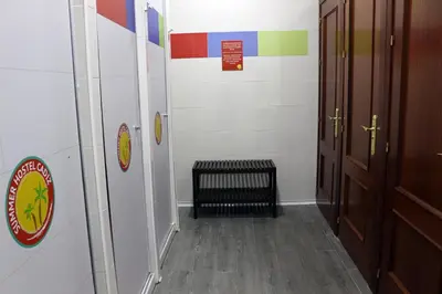 a hallway with a door and a bench in a room at Summer Cádiz in Cádiz