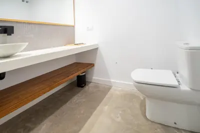 a bathroom with a white toilet and a sink at Apartamentos Son de Cadiz in Cádiz