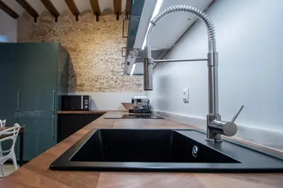 a kitchen with a sink and a faucet at Apartamentos Son de Cadiz in Cádiz