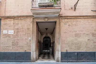 an alley way to a building with a door at Apartamentos Son de Cadiz in Cádiz