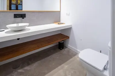 a bathroom with a sink and a toilet at Apartamentos Son de Cadiz in Cádiz
