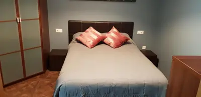 a bed with two pillows on it in a room at LA CASA DE HERACLES CADIZ in Cádiz
