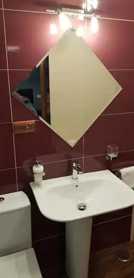 a bathroom with a sink and a mirror and a toilet at LA CASA DE HERACLES CADIZ in Cádiz