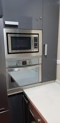 a kitchen with a stainless steel oven and microwave at LA CASA DE HERACLES CADIZ in Cádiz