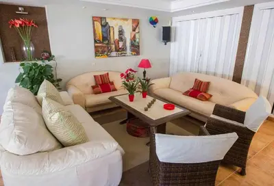 a living room with white furniture and a table at Chalet Villa Ventolera Novo Sancti Petri Chiclana in Chiclana de la Frontera