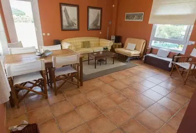 a living room with a table and a couch at Chalet Villa Ventolera Novo Sancti Petri Chiclana in Chiclana de la Frontera