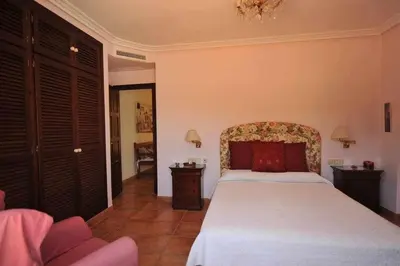 a bedroom with a large bed in a room at Chalet Villa Ventolera Novo Sancti Petri Chiclana in Chiclana de la Frontera