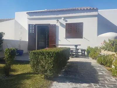 a house with a picnic table in front of it at Villa chillout la barrosa in Chiclana de la Frontera