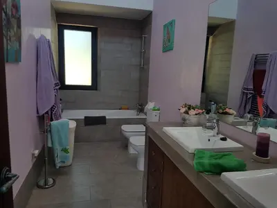 a bathroom with a sink and a toilet and a tub at Villa chillout la barrosa in Chiclana de la Frontera