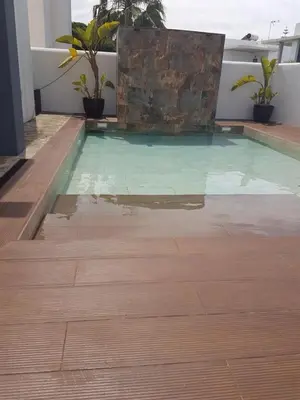 a pool in the middle of a house with a wooden floor at Villa chillout la barrosa in Chiclana de la Frontera