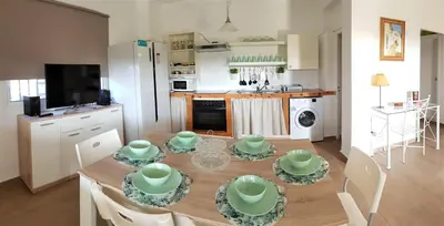 a kitchen and dining room with a table and chairs at Casa Rural El Pinar de Jesus in Arcos de la Frontera