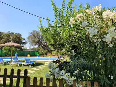 a yard with a fence and a swimming pool at Casa Rural El Pinar de Jesus in Arcos de la Frontera