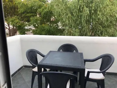 a black table and chairs sitting on a patio at Apartamento en La Almadraba in Chiclana de la Frontera