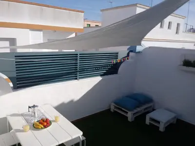 a balcony with a table and a bowl of fruit at Apartamento Rotasol in Rota