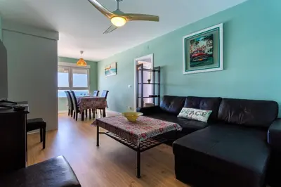 a living room with a couch and a table at GAVIOTA Family Home free parking by Cadiz4Rentals in Cádiz