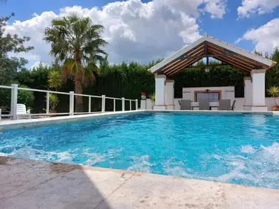 a swimming pool with a gazebo at Villa El Estanque Holiday Cottage & Bungalow in Arcos de la Frontera