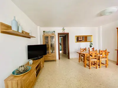 a kitchen with blue cabinets and a washing machine at La Araucaria de Chipiona in Chipiona