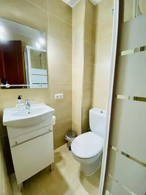 a bathroom with a staircase with a light on the wall at La Araucaria de Chipiona in Chipiona