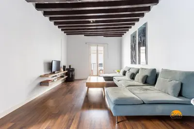 a living room with a blue couch and wooden floors at Diana de Columela by Cadiz Time in Cádiz