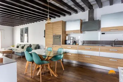 a kitchen and living room with a glass table and chairs at Diana de Columela by Cadiz Time in Cádiz