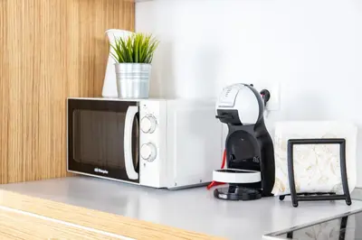 a coffee maker sitting on a counter next to a microwave at Diana de Columela by Cadiz Time in Cádiz