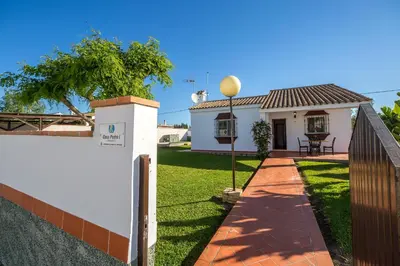 a house with a fence and a yard at Chalet Pedro I in Conil de la Frontera