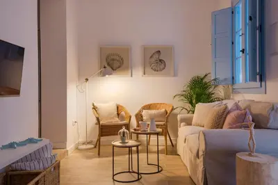 a living room with a couch and chairs at Apartamento Cádiz Centro Blue Window in Cádiz