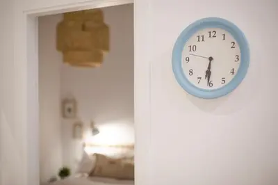 a clock hanging on a wall in a room at Apartamento Cádiz Centro Blue Window in Cádiz
