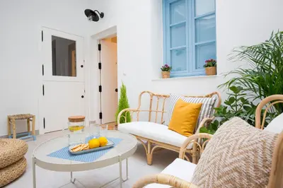 a patio with a table and chairs with fruit on it at Apartamento Cádiz Centro Blue Window in Cádiz