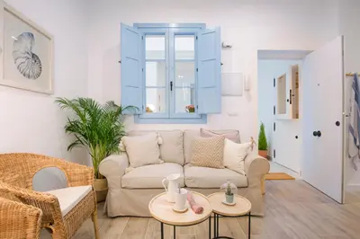 a living room with a couch and a table at Apartamento Cádiz Centro Blue Window in Cádiz