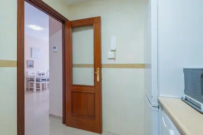 a bathroom with a wooden door and a table at Apartamento Vista Azul in Costa Ballena