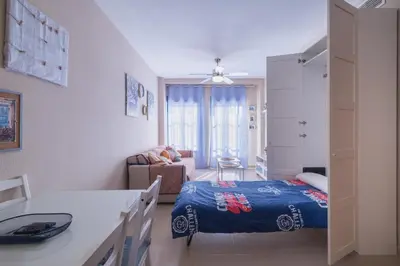 a small room with a bed and a living room at Apartamento Vista Azul in Costa Ballena