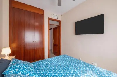 a bedroom with a bed and a television on the wall at Apartamento Vista Azul in Costa Ballena