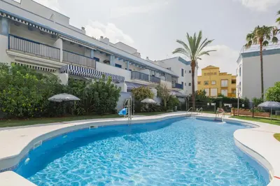 a large swimming pool in front of a building at Apartamento Vista Azul in Costa Ballena