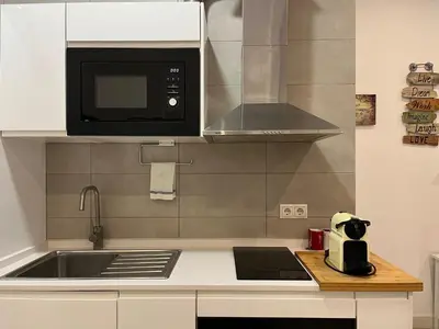 a kitchen with a sink and a microwave at Rinconcito del Falla Grupo AC Gestion in Cádiz