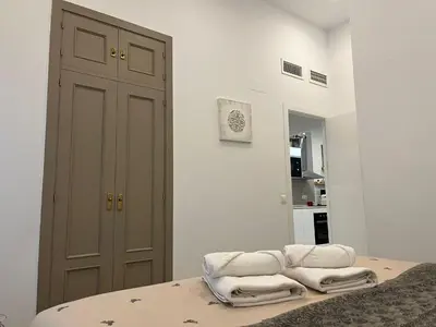 a room with a bed with two towels on it at Rinconcito del Falla Grupo AC Gestion in Cádiz