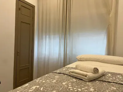 a bedroom with a bed with a towel on it at Rinconcito del Falla Grupo AC Gestion in Cádiz