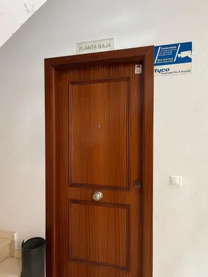 a wooden door in a room with a sign above it at Rinconcito del Falla Grupo AC Gestion in Cádiz